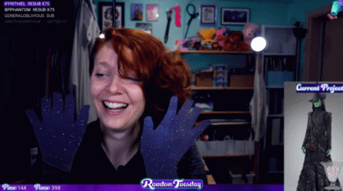 A Woman Is Laughing In Front Of A Screen That Says Random Tuesday On It GIF