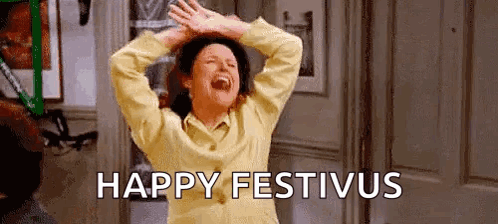 A Woman Is Laughing With Her Hands In The Air And The Words `` Happy Festivus '' Written On The Bottom . GIF