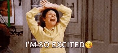 A Woman Is Laughing With Her Hands In The Air And The Words `` I 'M So Excited '' Written Below Her . GIF