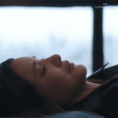 A Woman Is Laying Down With Her Eyes Closed In Front Of A Window With Icememo.tv Written On The Bottom GIF