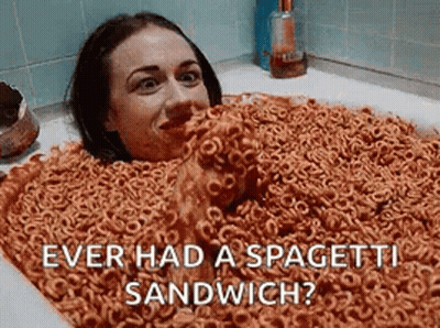 A Woman Is Laying In A Bathtub Filled With Cereal And Spaghetti . GIF