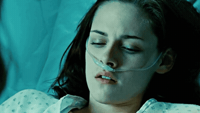A Woman Is Laying In A Hospital Bed With An Oxygen Mask On Her Nose GIF