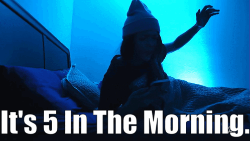 a woman is laying in bed with the words it 's 5 in the morning