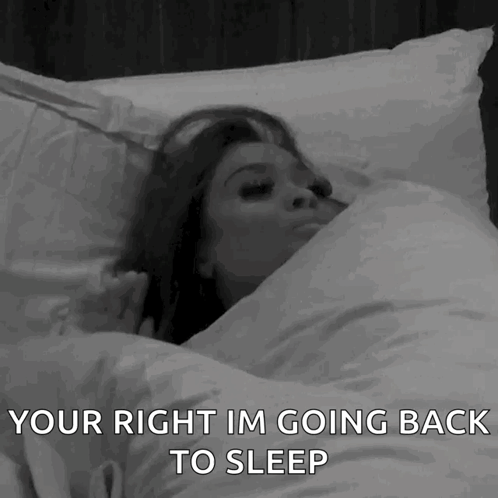 A Woman Is Laying In Bed With The Words " Your Right Im Going Back To Sleep " Above Her GIF