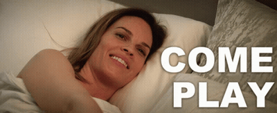 A Woman Is Laying On A Bed With The Words Come Play Behind Her GIF