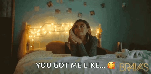 A Woman Is Laying On A Bed With The Words " You Got Me Like " Above Her GIF