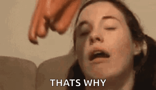 A Woman Is Laying On A Couch With Her Eyes Closed And A Person Pointing At Her Face . GIF