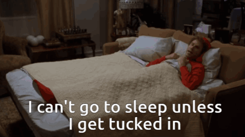 A Woman Is Laying On A Couch With The Words " I Can 'T Go To Sleep Unless I Get Tucked In " GIF
