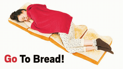 A Woman Is Laying On A Slice Of Bread With The Words Go To Bread Behind Her GIF