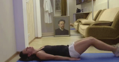 A Woman Is Laying On A Yoga Mat In Front Of A Couch And A Painting Of A Man . GIF