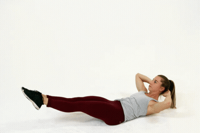 A Woman Is Laying On The Floor Doing A Crunch Exercise GIF
