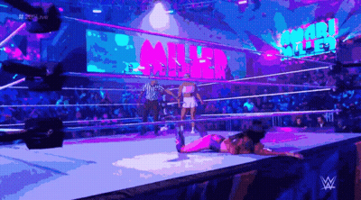 A Woman Is Laying On The Ground In A Wrestling Ring With The Word Miller Behind Her GIF