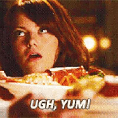 A Woman Is Looking At A Bowl Of Food And Saying Ugh Yum ! GIF