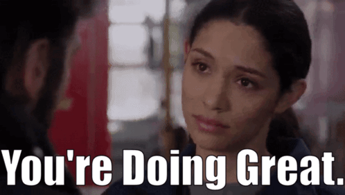 A Woman Is Looking At A Man With The Words `` You 'Re Doing Great '' Written Below Her . GIF