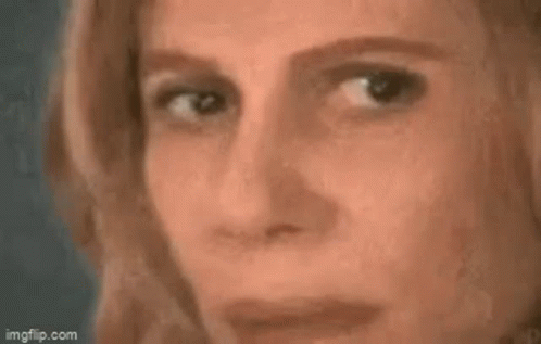 A Woman Is Looking At A Triangle On A Blackboard With A Math Problem . GIF