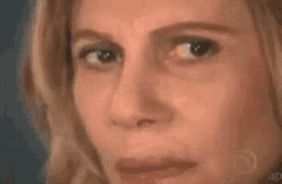 A Woman Is Looking At A Triangle With A Mathematical Equation Written On It . GIF