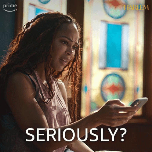 A Woman Is Looking At Her Phone And The Word Seriously Is On The Screen GIF