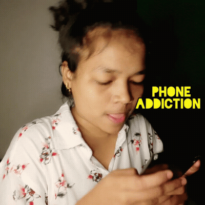 A Woman Is Looking At Her Phone With The Words Phone Addiction Written Above Her GIF