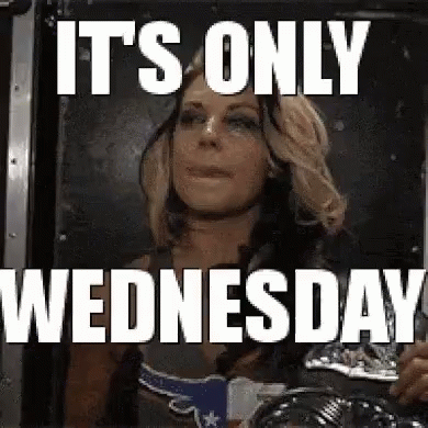 A Woman Is Looking At Herself In A Mirror With The Words `` It 'S Only Wednesday '' Written Above Her . GIF