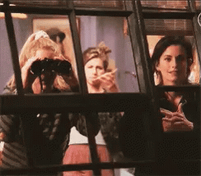 A Woman Is Looking Through Binoculars While Another Woman Looks On GIF
