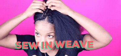 A Woman Is Making A Braid In Her Hair . GIF