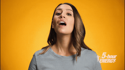 A Woman Is Making A Face In Front Of A Yellow Background With 5 Hour Energy Written On It GIF