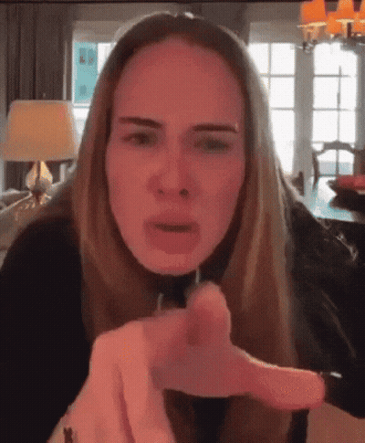 A Woman Is Making A Funny Face And Pointing At The Camera GIF
