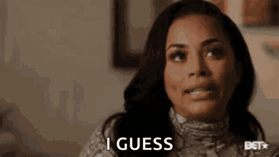A Woman Is Making A Funny Face And Saying `` I Guess '' While Sitting At A Table . GIF