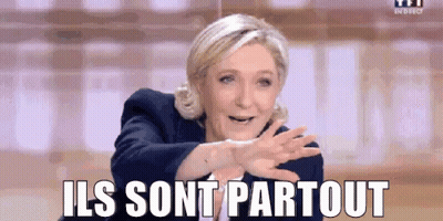 A Woman Is Making A Funny Face And Saying `` Ils Sont Partout '' With Her Hands Outstretched . GIF