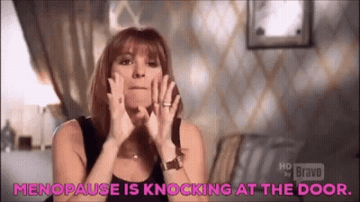 A Woman Is Making A Funny Face And Says `` Menopause Is Knocking At The Door . '' GIF