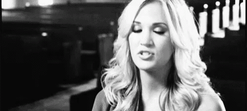 A Woman Is Making A Funny Face In A Black And White Photo . GIF