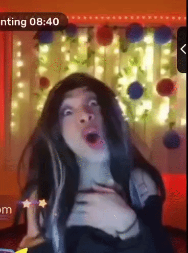 A Woman Is Making A Funny Face In Front Of A Screen That Says ' Nting 8:40 ' GIF