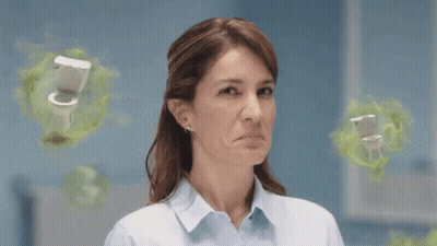 A Woman Is Making A Funny Face In Front Of A Toilet . GIF