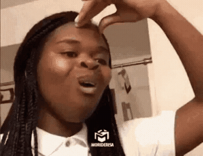 A Woman Is Making A Funny Face While Holding Her Nose . GIF