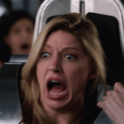 A Woman Is Making A Funny Face While On A Roller Coaster GIF