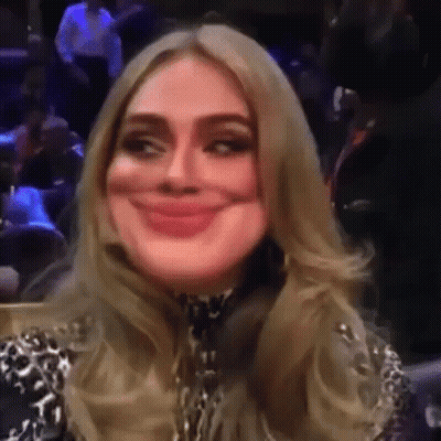 A Woman Is Making A Funny Face While Sitting In A Stadium . GIF