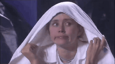 A Woman Is Making A Funny Face While Wearing A White Cloth Over Her Head GIF