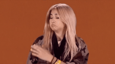A Woman Is Making A Funny Face While Wearing A Wristband That Says ' A ' On It GIF