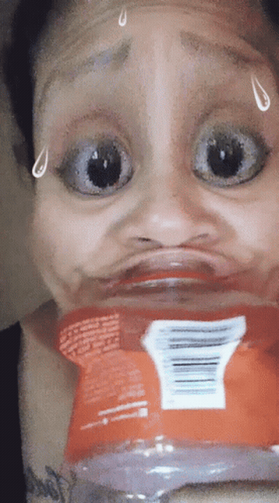 A Woman Is Making A Funny Face With A Bag Of Chips GIF