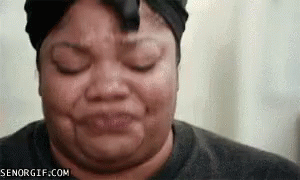 A Woman Is Making A Funny Face With Her Eyes Closed GIF