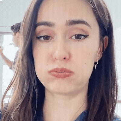 A Woman Is Making A Funny Face With Her Mouth Open . GIF