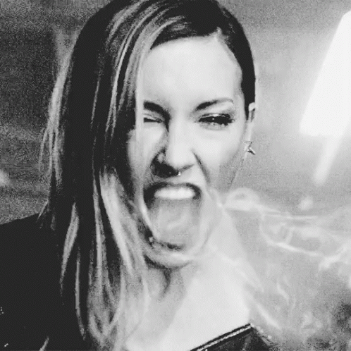 A Woman Is Making A Funny Face With Her Mouth Open GIF