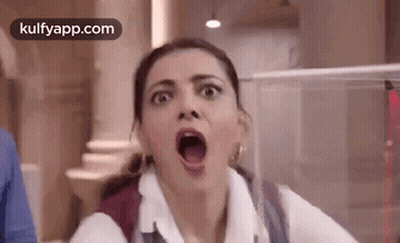 A Woman Is Making A Funny Face With Her Mouth Open And A Backpack . GIF