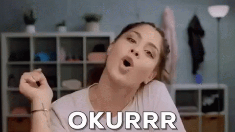 A Woman Is Making A Funny Face With Her Mouth Open And The Word Okurrr Written On Her Face . GIF
