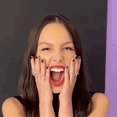 A Woman Is Making A Funny Face With Her Mouth Open . GIF
