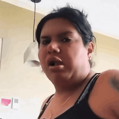 A Woman Is Making A Funny Face With Her Mouth Open GIF