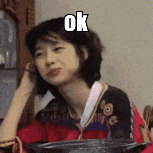 A Woman Is Making A Funny Face With The Word Ok Above Her GIF