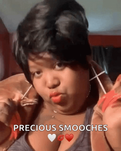 A Woman Is Making A Funny Face With The Words Precious Smooches In The Corner GIF