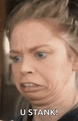 A Woman Is Making A Funny Face With The Words `` U Stank '' Written Next To Her . GIF