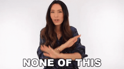A Woman Is Making A Gesture With Her Hands And The Words None Of This Are Behind Her . GIF